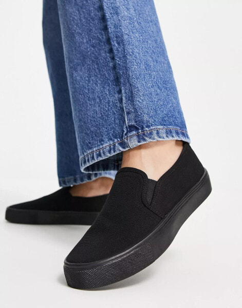 ASOS DESIGN Dotty slip on plimsolls in black