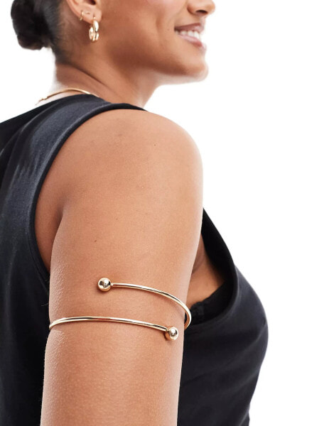 ASOS DESIGN Curve arm cuff with wraparound design with ball ends in gold tone