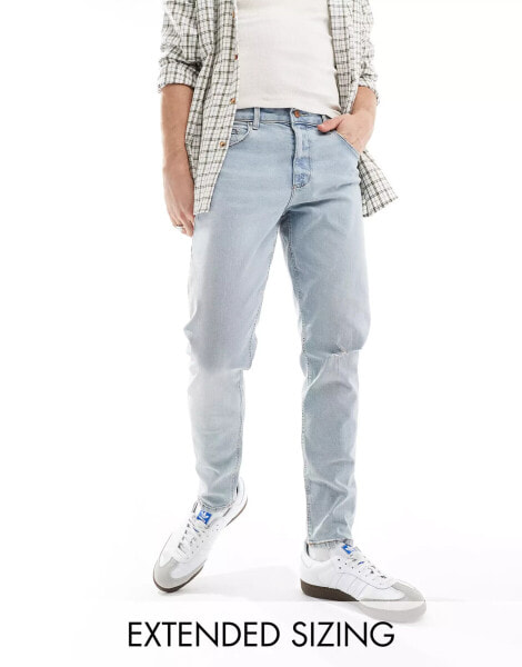 ASOS DESIGN tapered jeans in light wash blue