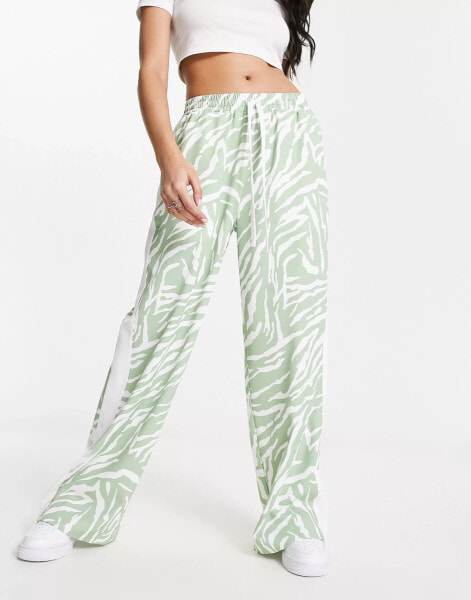 ASOS DESIGN pull on trouser with contrast panel in animal print in sage