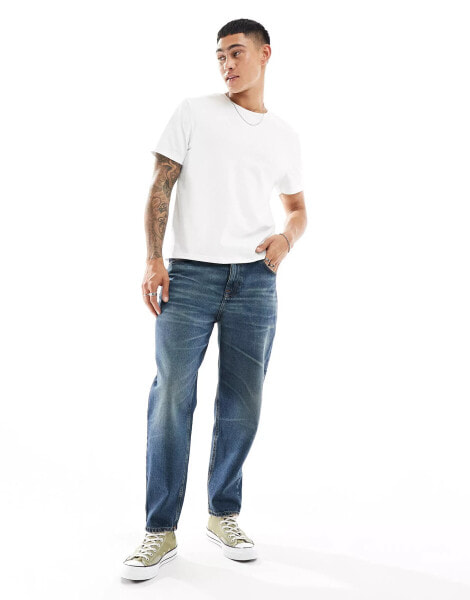 ASOS DESIGN tapered jeans in dark wash blue