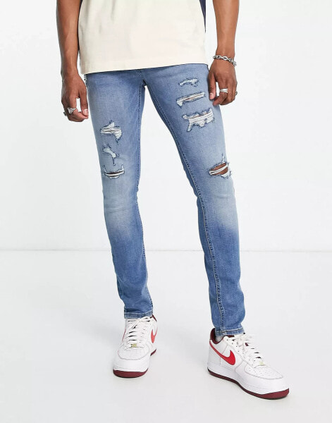 Jack & Jones Intelligence – Liam – Enge Jeans mit Zierrissen in Blau