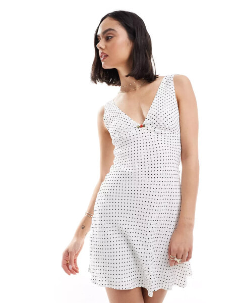 Bershka tie back mini dress in white and black spot