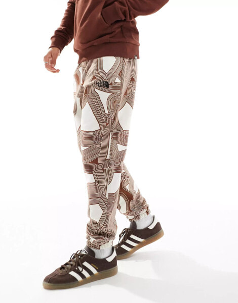 The North Face Essential oversized fleece joggers in brown geo print Exclusive at ASOS