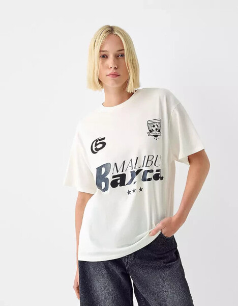 Bershka oversized 'Malibu' graphic football tee in ecru