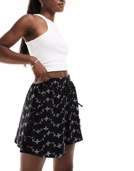 ASOS DESIGN broderie shorts with tie pockets in black/white