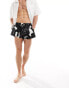 ASOS DESIGN swim shorts in super short length in black print