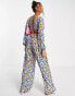 ASOS DESIGN bubble crepe button back long sleeve jumpsuit in blue floral