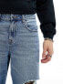 ASOS DESIGN baggy jeans with with rips in mid wash blue