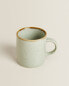 Porcelain mug with antique finish rim