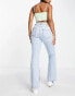 Only mid rise split hem flared jeans with distressing in light wash