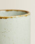 Porcelain mug with antique finish rim