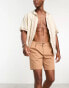 ASOS DESIGN pleated shorts in mid length in tan