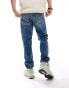 ASOS DESIGN tapered jeans in mid blue wash with carpenter details