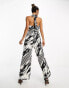 River Island halterneck tie back wide leg jumpsuit in black and white