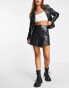 Reclaimed Vintage leather look mini skirt in black with hardware detail