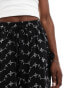 ASOS DESIGN broderie shorts with tie pockets in black/white