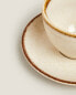 Porcelain teacup with antique finish rim