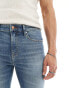 ASOS DESIGN flared jeans in mid wash blue