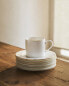 Rimmed bone china teacup and saucer