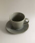 Glazed stoneware teacup and saucer