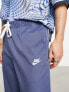 Nike Club woven tapered trousers in blue