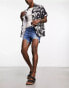 ASOS DESIGN shorter length denim shorts in midwash with rip detail and raw hem