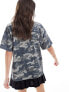 ASOS DESIGN oversized t-shirt with graphic in washed camo print