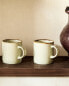 Porcelain mug with antique finish rim