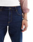 ASOS DESIGN tapered fit stretch jeans in dark wash blue