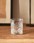 Crystalline tumbler with raised design