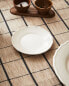 Earthenware side plate with raised-design edge