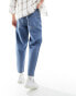 ASOS DESIGN tapered jeans with abrasions in mid wash blue