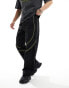 ASOS DESIGN panelled piping track pants in black and yellow sheen nylon