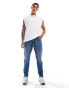 ASOS DESIGN stretch tapered jeans in mid wash blue