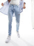 ASOS DESIGN skinny jeans in light wash blue with thigh rip