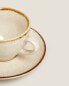 Porcelain teacup with antique finish rim