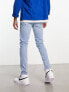 ASOS DESIGN skinny jeans in light wash blue with thigh rip