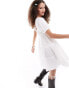 Monki textured babydoll mini dress with tiered hem and puff sleeves in white