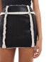 SNDYS leather look contrast borg detail mini skirt co-ord in black