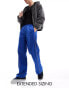 ASOS DESIGN baggy nylon track pants in blue with white piping