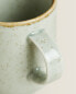 Porcelain mug with antique finish rim