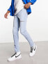 ASOS DESIGN skinny jeans in light wash blue with thigh rip