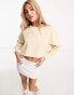 Calvin Klein Jeans cropped crew neck seaming sweatshirt in beige - exclusive to ASOS