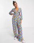 ASOS DESIGN bubble crepe button back long sleeve jumpsuit in blue floral