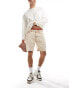 Liquor N Poker distressed cross denim shorts in beige