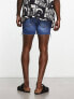 ASOS DESIGN shorter length denim shorts in midwash with rip detail and raw hem