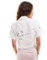 Reclaimed Vintage tie front western shirt with tablecloth embroidery detail in white