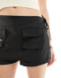 Lioness tie side skort with pocket detail in black