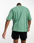 ASOS DESIGN oversized t-shirt in green with gothic text chest print